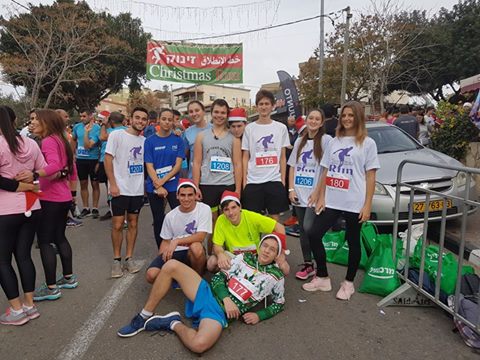 Image may contain: 14 people, people smiling, shoes and outdoor